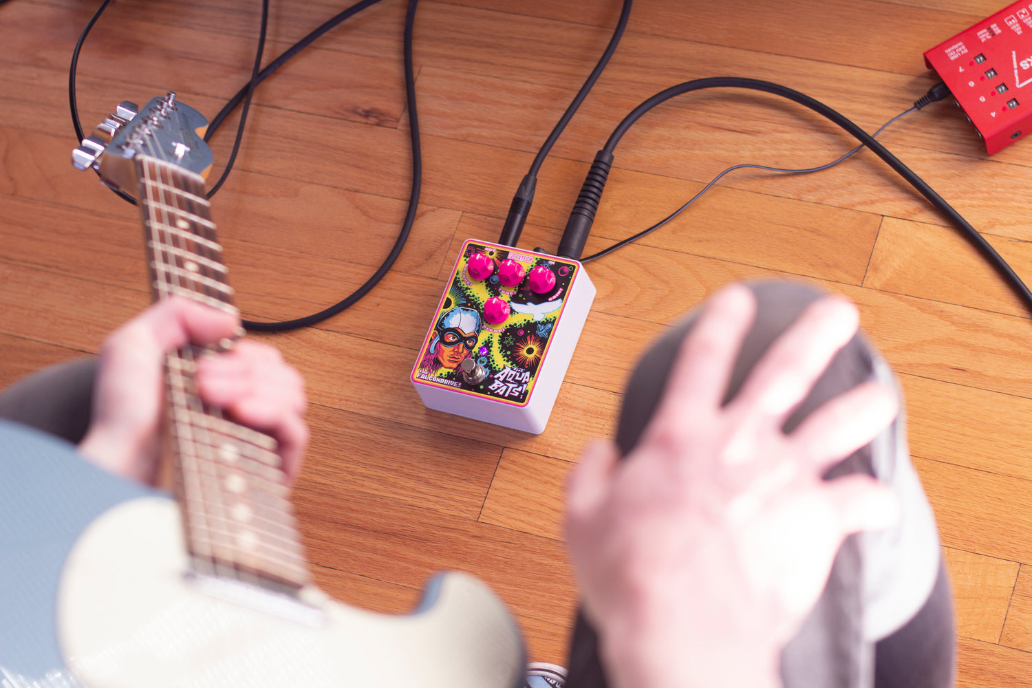 A guitar player viewing thier The Falcondrive! overdrive/distortion dual-effect guitar pedal.
